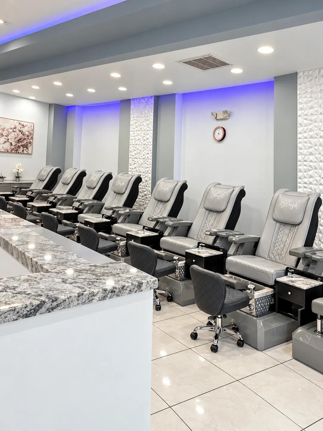 The pedicure suite at Blush Nail Lounge, with a row of spa chairs and the Blush name on each headrest